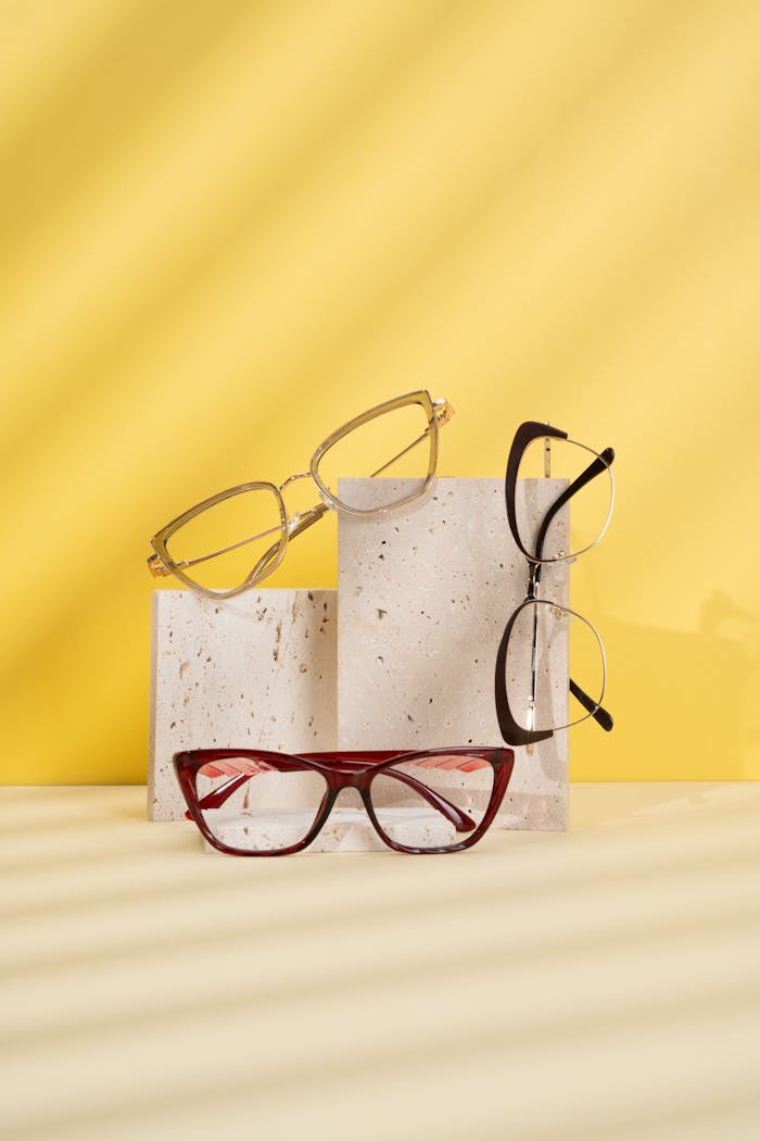 Modern eyeglasses displayed on a yellow background, featuring a chic aesthetic.